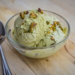 Dubai style croissant with pistachio cream and crispy kataifi topping showing flaky buttery layers